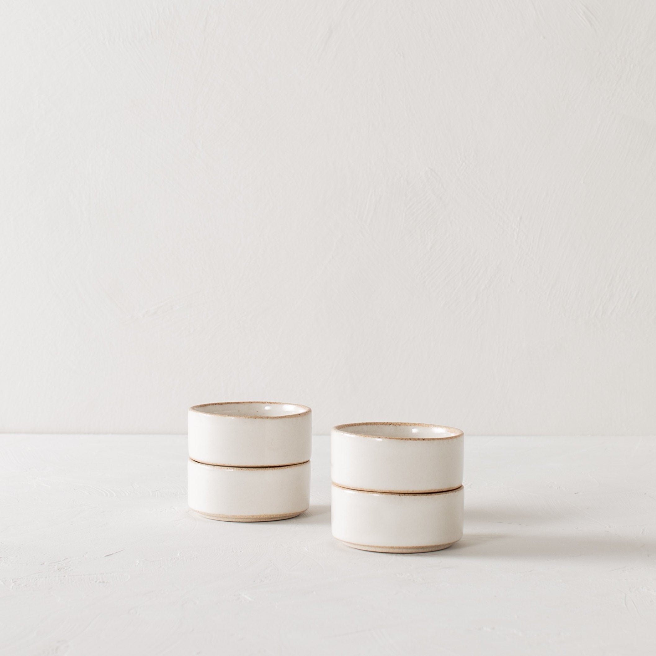 Four ramekin dishes stacked in two stacks of two. Ramekin dishes have exposed stoneware on the rim and base. Handmade ceramic ramekin, designed and sold by Convivial Production, Kansas City ceramics. 
