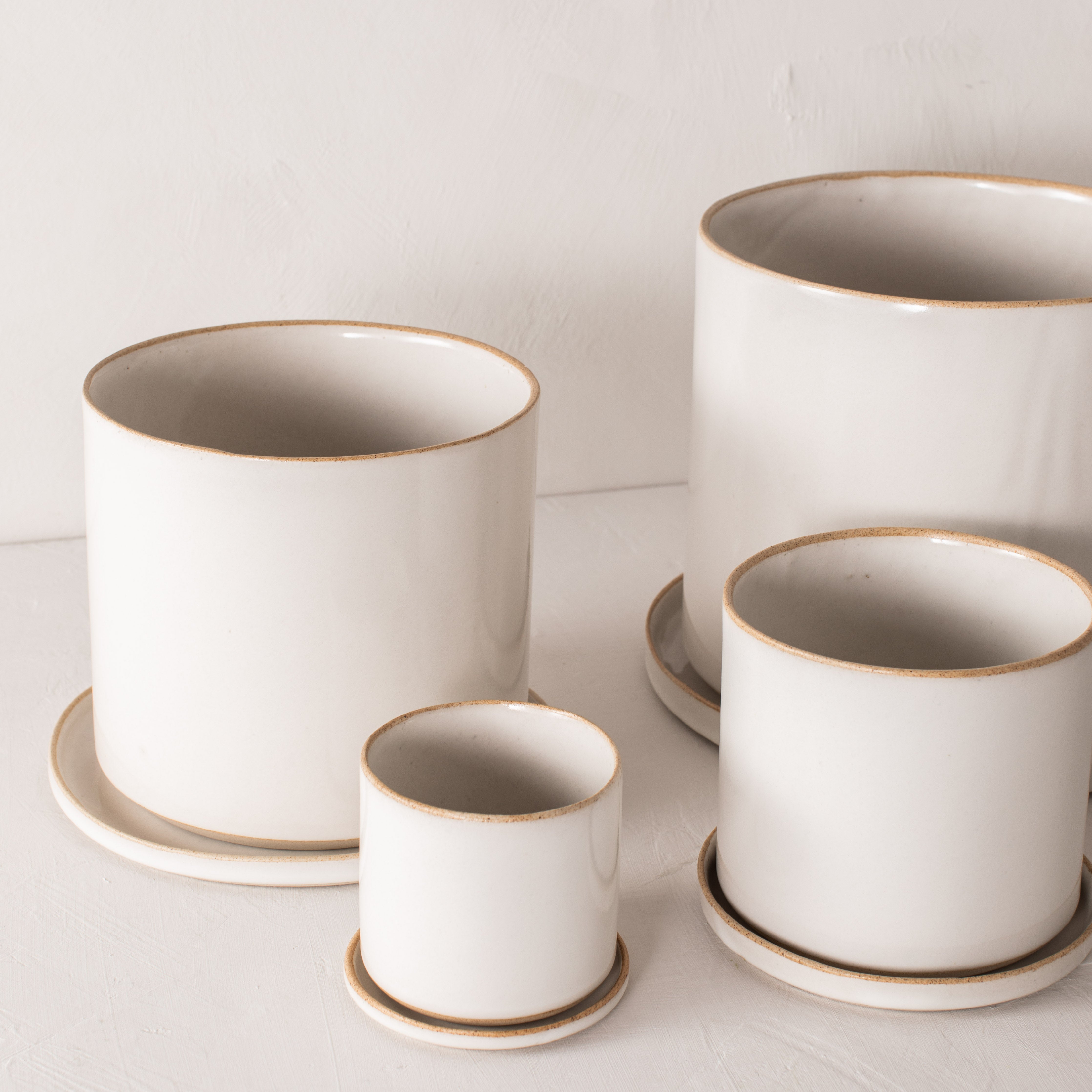 Group of four minimal white planters, 4, 6, 8, and 10 inch. Designed and sold by Convivial Production, Kansas City ceramics. 